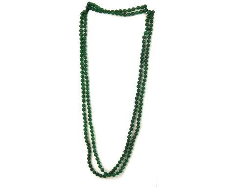 A long single strand necklace of 6mm polished jade beads, necklace L. 210cm.