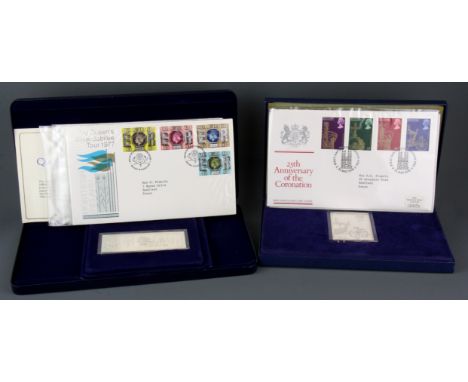 Two boxed sterling silver jubilee commemorative ingots and first day cover stamps.