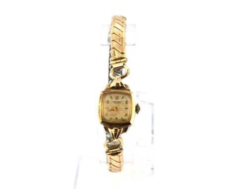 A vintage ladies Rotary 9ct gold wrist watch on a gilt expandable strap.