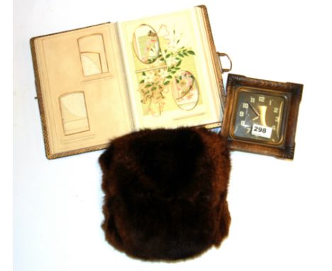 A Victorian leather photograph album, a fur muff and a Smith alarm clock.