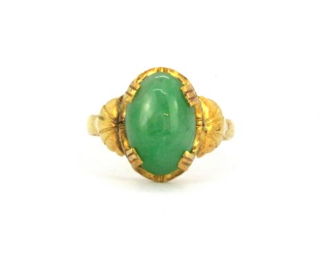 A yellow metal (tested high carat gold) ring set with a 3.9ct cabochon cut natural untreated jadeite jade, with GCS certifica