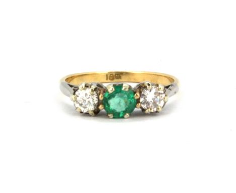 An 18ct yellow and white gold ring set with a round cut emerald flanked by brilliant cut diamonds, approx. 0.50ct overall, (K