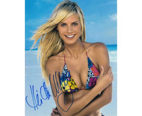 Heidi Klum signed 10 x 8 colour photo. Sexy swimsuit portrait of the supermodel.   Good condition.  All items come with a Cer