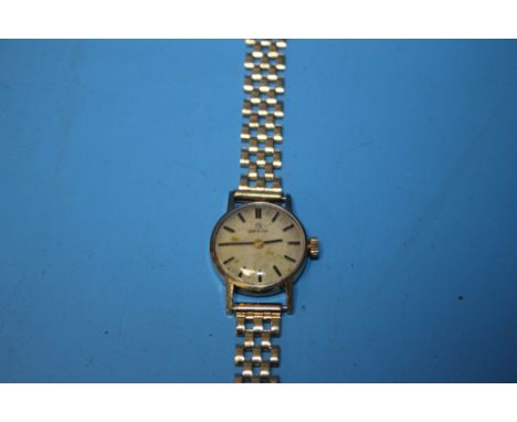 A LADIES OMEGA MANUAL WIND WRIST WATCH on an unbranded 9 ct gold strap, dedication inscription to the back