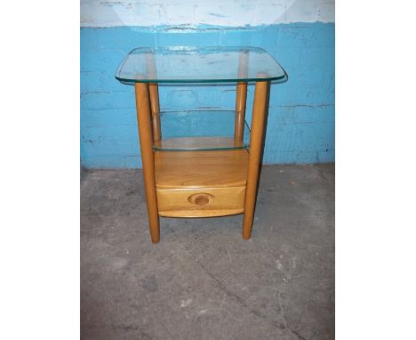 A BLONDE ERCOL GLASS TOPPED SIDE TABLE WITH DRAWER