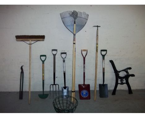 A QUANTITY OF MOSTLY NEW GARDEN TOOLS AND A PAIR OF CAST BENCH ENDS