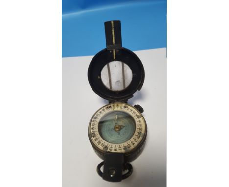 A CASED MILITARY TYPE COMPASS
