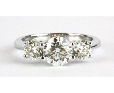 An 18ct white gold (stamped 750) ring set with three brilliant cut diamonds, approx. 1.16ct centre and 0.68 shoulders, (M).