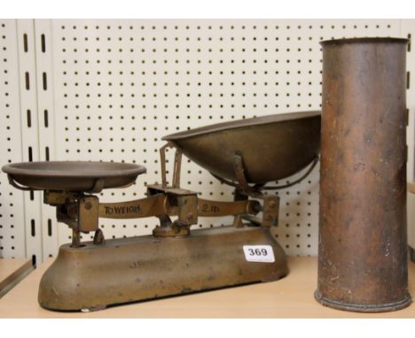 An early scale and weights, together with a brass shell case.