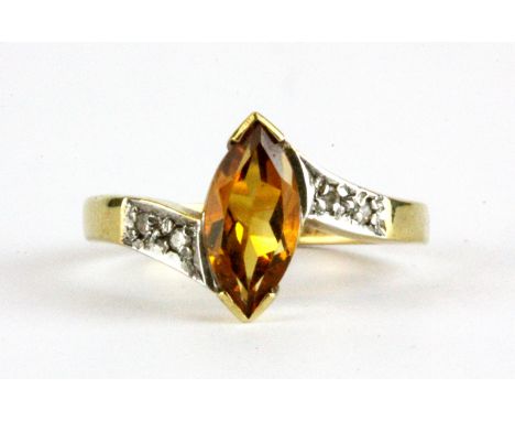 A 9ct yellow gold ring set with a marquise cut citrine and diamond set shoulders, (L.5).