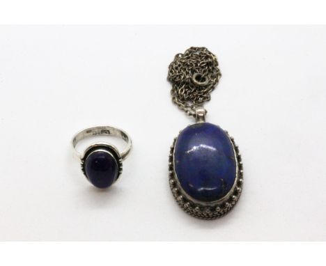 A 925 silver lapis lazuli set ring and a 925 silver lapis lazuli set pendant on a white metal chain.