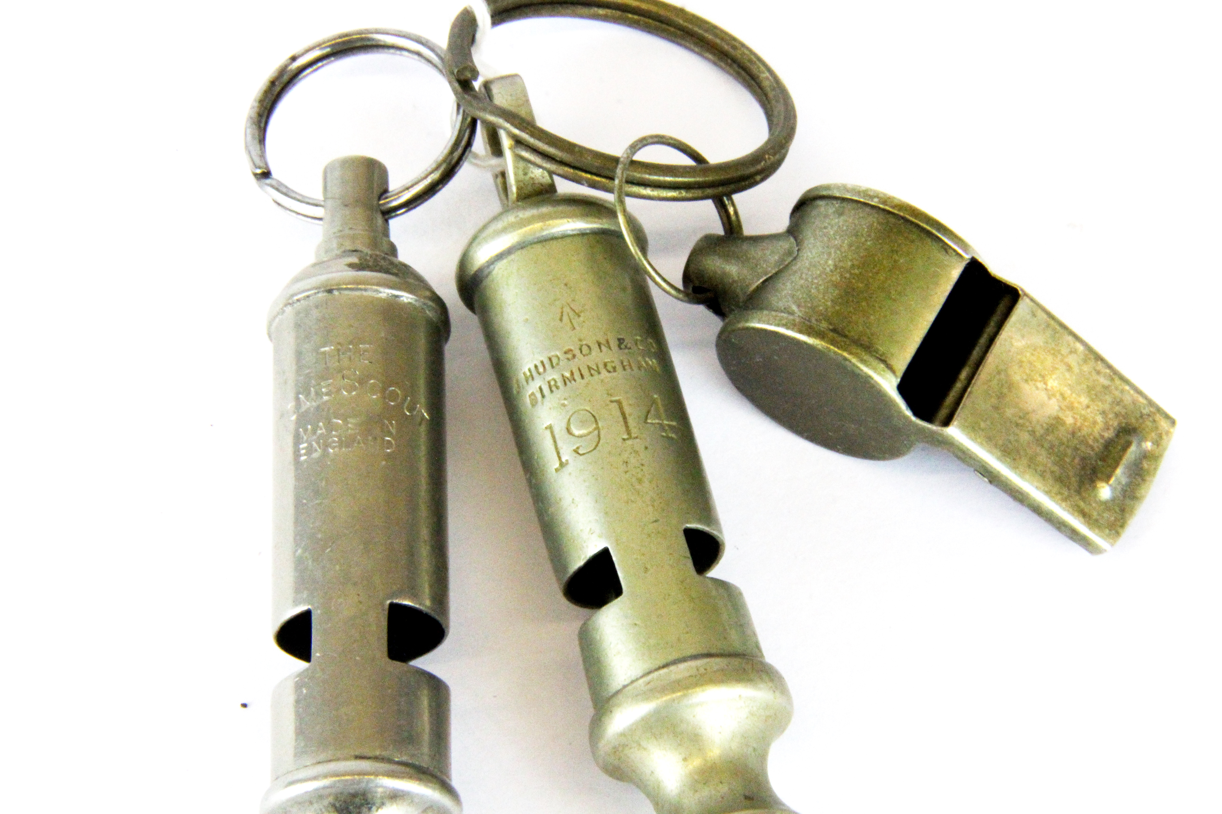 A 1914 police whistle, an Acme whistle and one other.