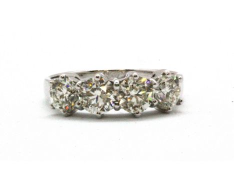 An 18ct white gold (stamped 18k) ring set with four brilliant cut diamonds, approx. 1.2ct overall, (N.5).