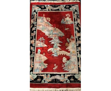 A large Chinese red ground washed wool carpet, 330 x 230cm.