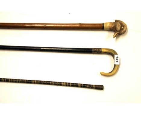 A hallmarked silver mounted horn handled walking stick and two others.