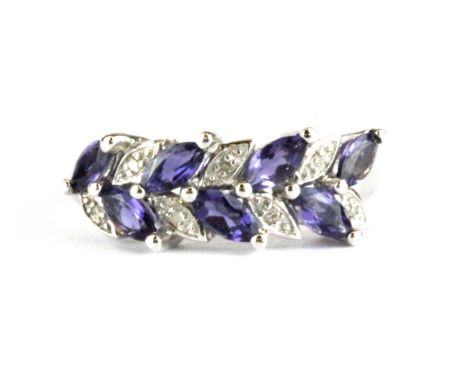 A 9ct white gold ring set with marquise cut tanzanites and diamonds, (P.5).