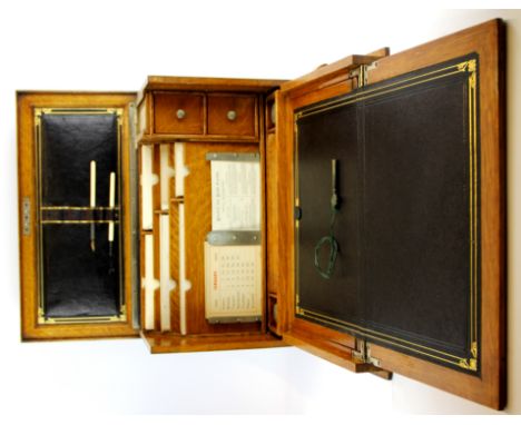 A 1900 fitted light oak writing slope and stationery box still with original calendar and envelopes, 29 x 42 x 23cm.