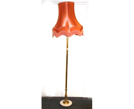 A vintage brass standard lamp with silk shade.