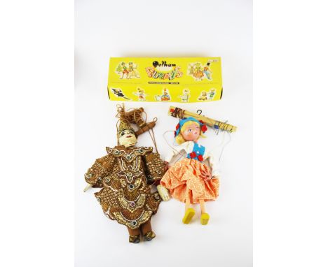 An Indonesian sequin decorated wooden puppet and a Pelham puppet.
