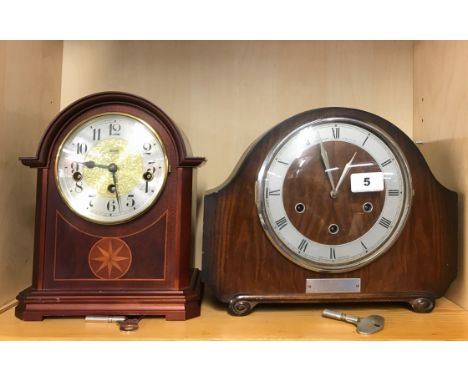An inlaid Hermle mahogany mantle clock and a further mantle clock.