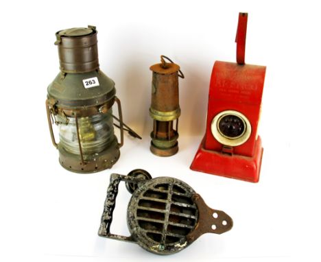 An air raid claxon, a vintage railway lamp together with a road lamp and pre-safety miner's lamp..