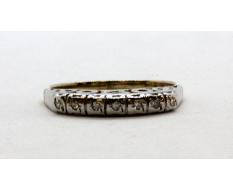 A 9ct yellow and white gold diamond set half eternity ring, (L.5).