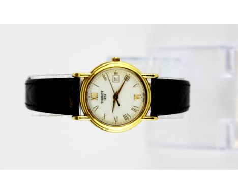 A boxed lady's Tissot 18ct yellow gold (stamped 18k) wrist watch on a leather strap.