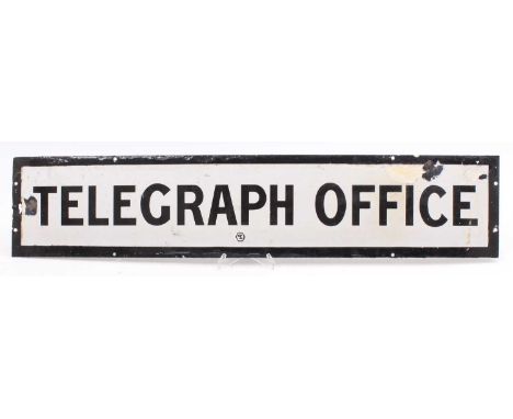 An original white enamel sign marked "Telegraph Office" has 8 fixing holes, some repaired damage to either end and measures 2