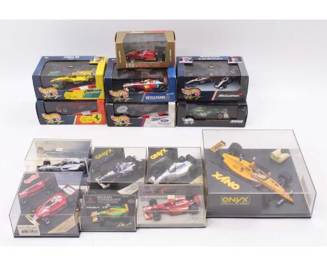 A collection of Formula 1 diecasts, including a 1/43rd scale Hot Wheels 1999 Ferrari F399, a Minichamps Williams FW22 as driv