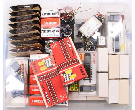 Lidded plastic crate containing: 16 H&amp;M point switches ref H700 FS2, unopened in original packets; 11 Fleischmann 6012 tr