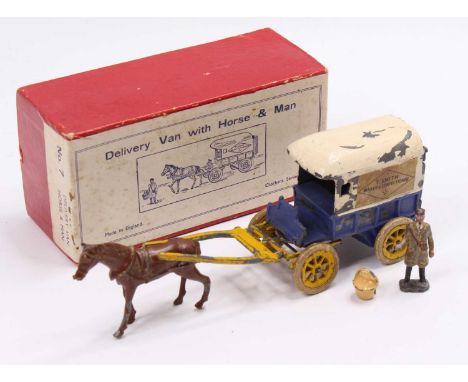 A Charbens No. 7 lead hollow cast model of a baker's delivery van with horse and attendant figure, together with one basket o