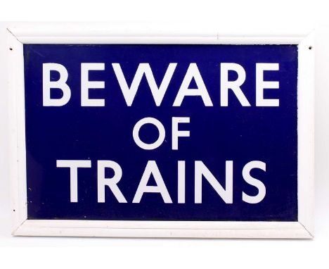 A wooden framed enamel sign "beware of trains". In excellent condition. measures 28 inches by 19 including the frames.