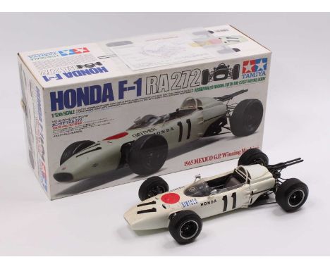 A Tamiya model No. 23201 1/12 scale factory built model of a Honda F1 RA272 race car (1965 Mexico Grand Prix Winning Machine)