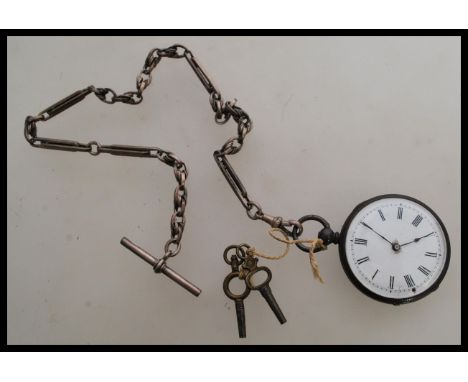 A 19th century Victorian silver pocket watch with an Albert chain attached and two winding keys. The watch having a white ena