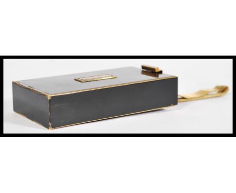 A vintage retro mid 20th Park Lane century brass compact with black enameled panels having a double opening with a compact se