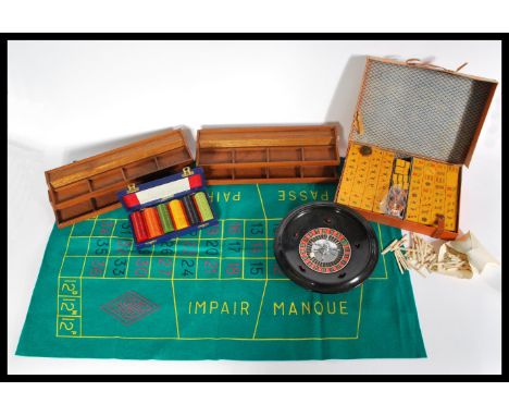 A selection of vintage 20th century boxed table games to include a Mahjong tile set, a set of casino chips, roulette wheel an