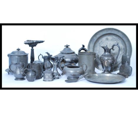 A collection of pewter dinner / tea set wares dating from the 19th century to include large candlestick, teapot, jugs, sander