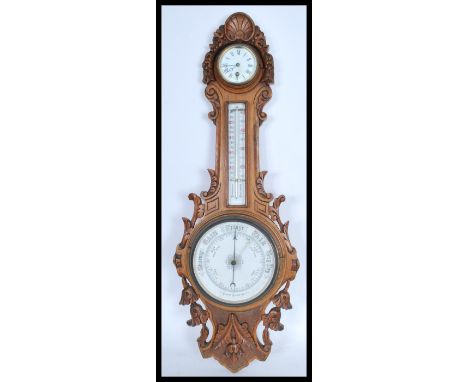 A 20th century Banjo shaped Aneroid oak cased barometer with including a clock face with Roman numeral characters and faceted