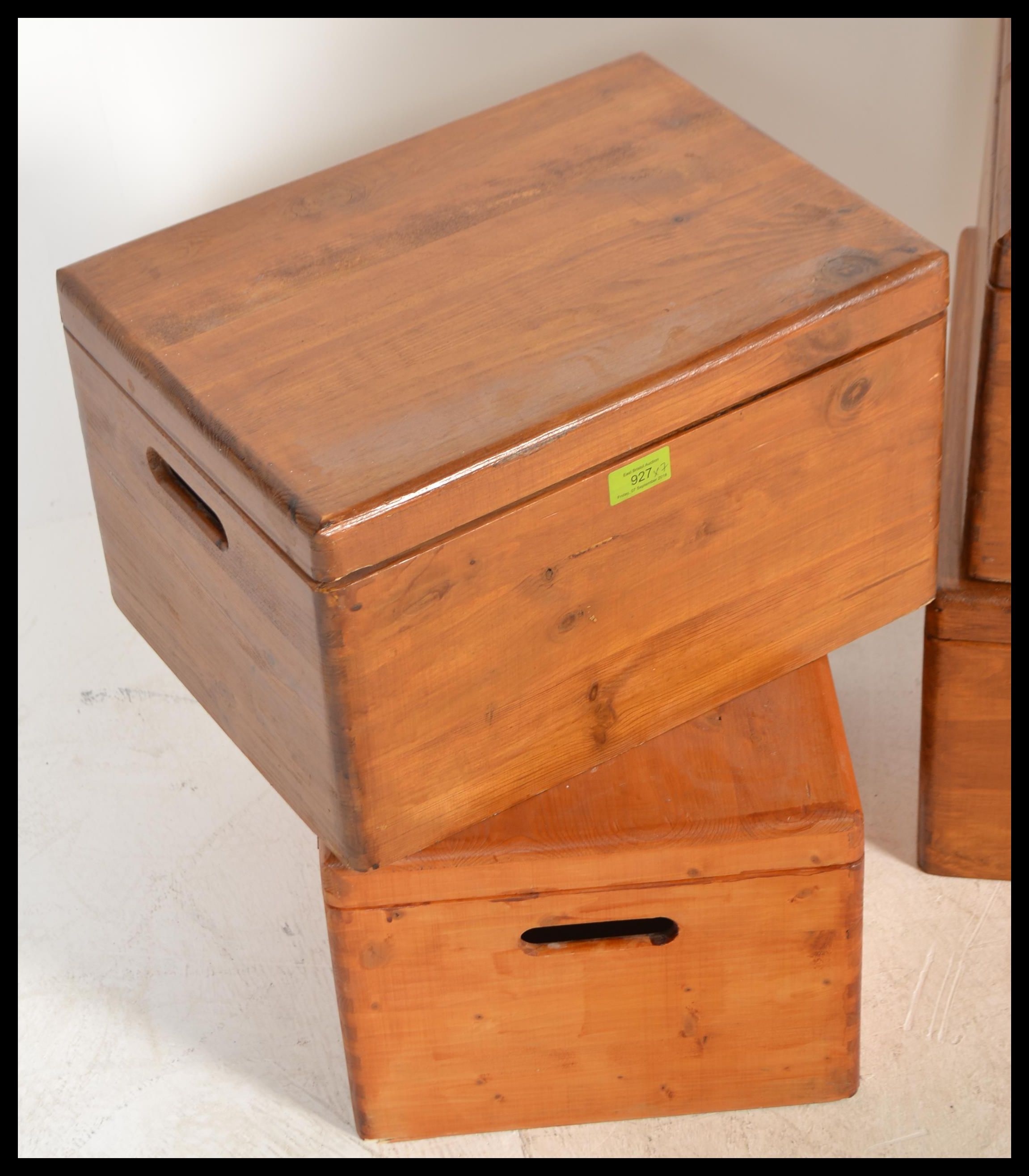 A collection of seven pine lidded storage boxes with carry handles to
