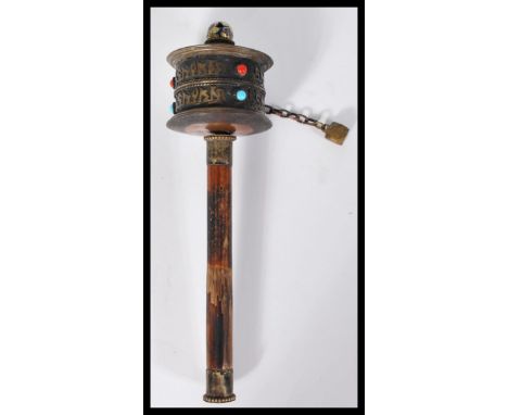 An antique 19th century Mongolian child's rattle spinner with calligraphy lettering and applied turquoise and red stones. Ena