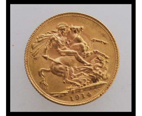 A 1914 London Mint gold sovereign featuring a portrait of George V facing left and a George dragon design to the verso. The c