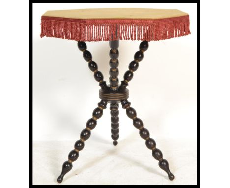 A 19th Century Victorian ebonised and gilt framed Gypsy table, with velvet covered top and raised on bobbin turned supports. 