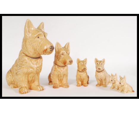 A collection of vintage 20th century SylvaC ceramic graduating dog figurines of brown terriers with matte glaze, numbers stam