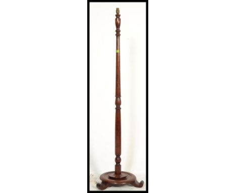 A vintage early 20th Century mahogany standard lamp and shade, on turned column upright supported by circular base.&nbsp;Meas