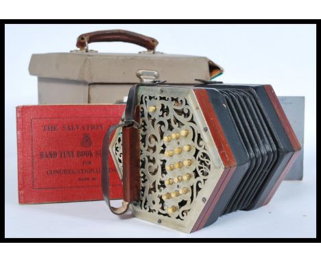 A mid 20th century Salvation Army rosewood squeeze box accordian musical instrument having a wooden case with metal ends and 