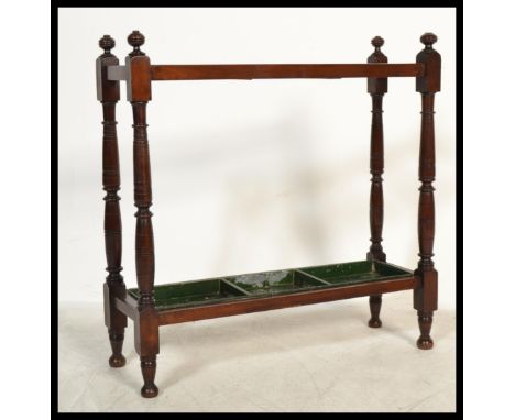 An early 20th century Edwardian mahogany walking stick stand with three compartments, having square and turned legs and a det