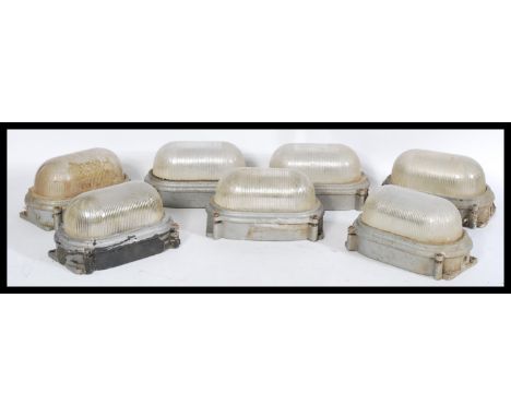 A set of seven vintage retro 20th century industrial prismatic bulkhead lights with brushed metal cases. Complete with cerami