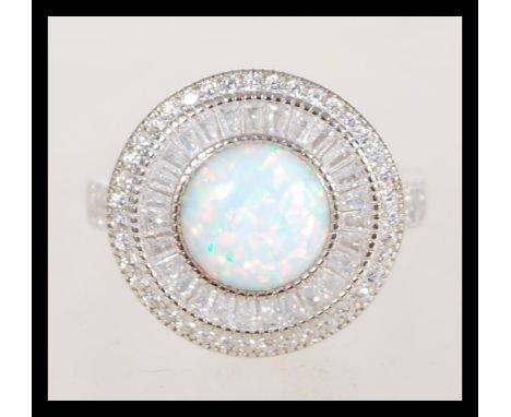 A 20th century Art Deco style ring with a large round central opal and cz set into the head and the shank, items weighs 8g, s