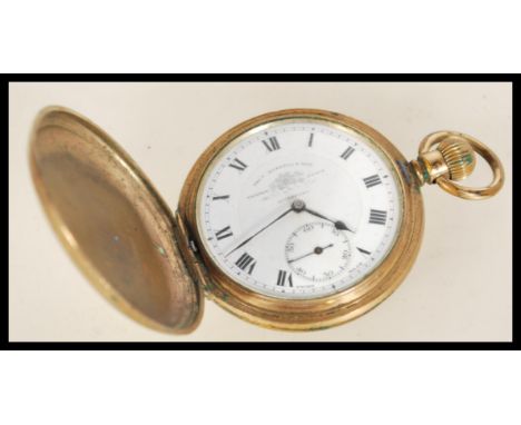 A vintage 20th century gold plated full hunter pocket watch by Tho Russell and Son Liverpool having a white enamel face with 