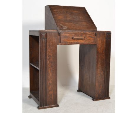 A 1930's Art Deco oak bureau desk having a central&nbsp; kneehole recess with fall front cover with fully appointed interior,